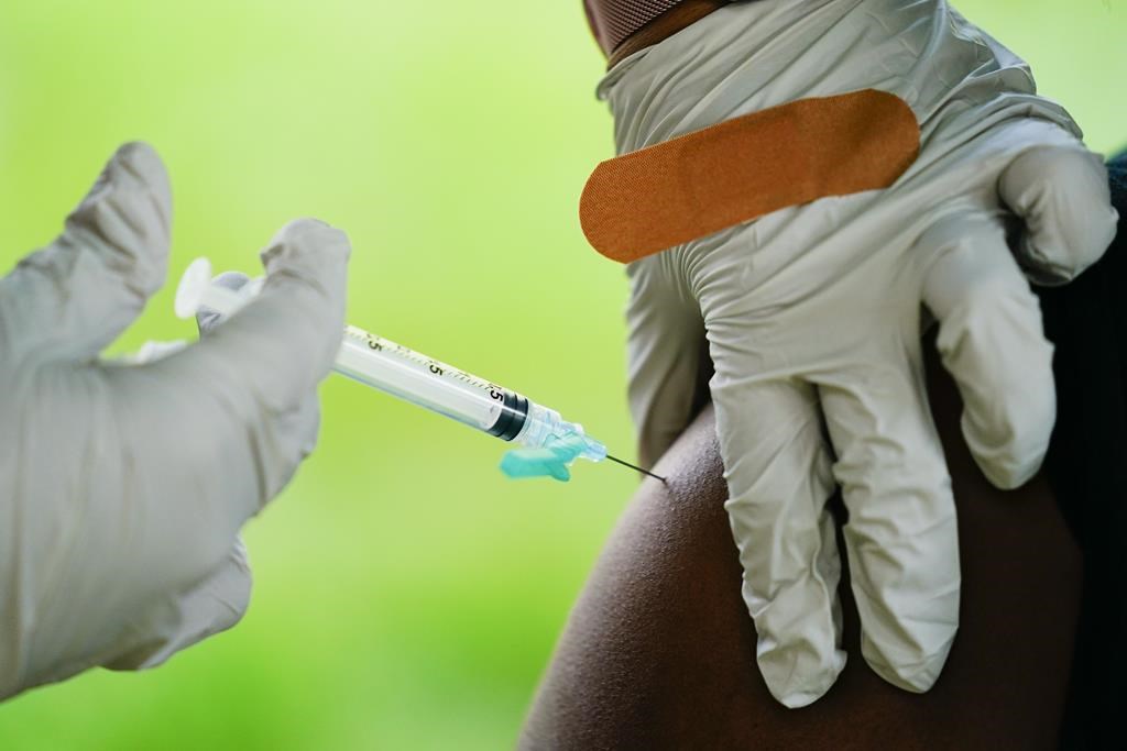 A health worker administers a dose of COVID-19 vaccine during a vaccination clinic in Reading, Pa. On Friday, April 7, 2023, The Associated Press reported on stories circulating online incorrectly claiming the World Health Organization now says COVID-19 vaccines are “not recommended” for healthy children and teens.