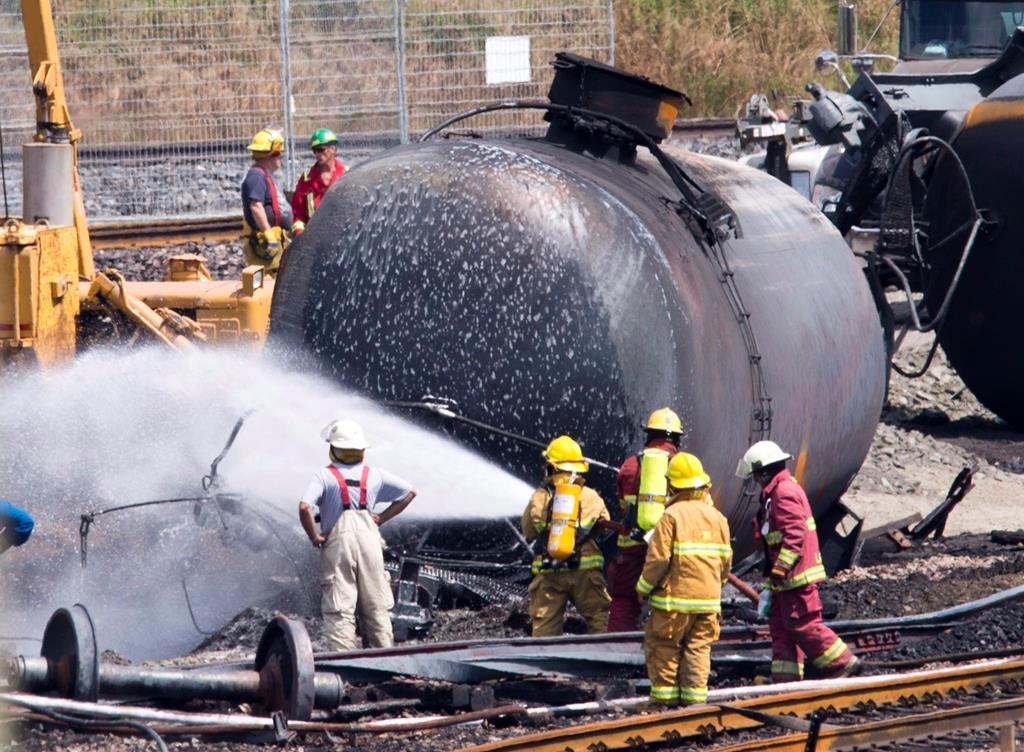 firefighter spraying down a tanker