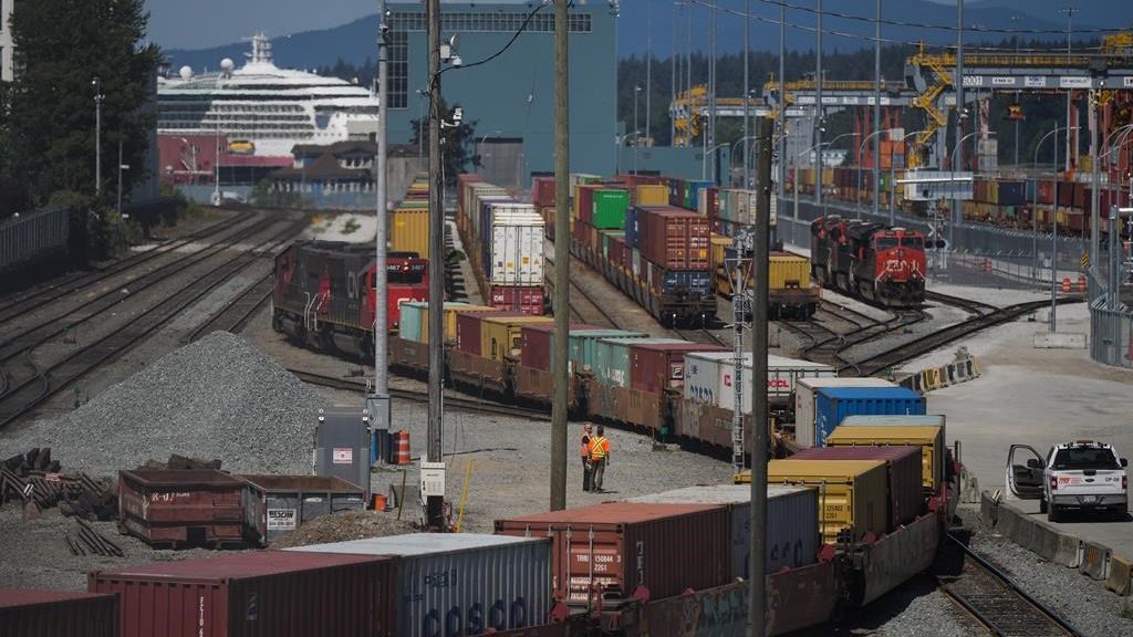 A CN Rail train moves cargo containers at the Centerm