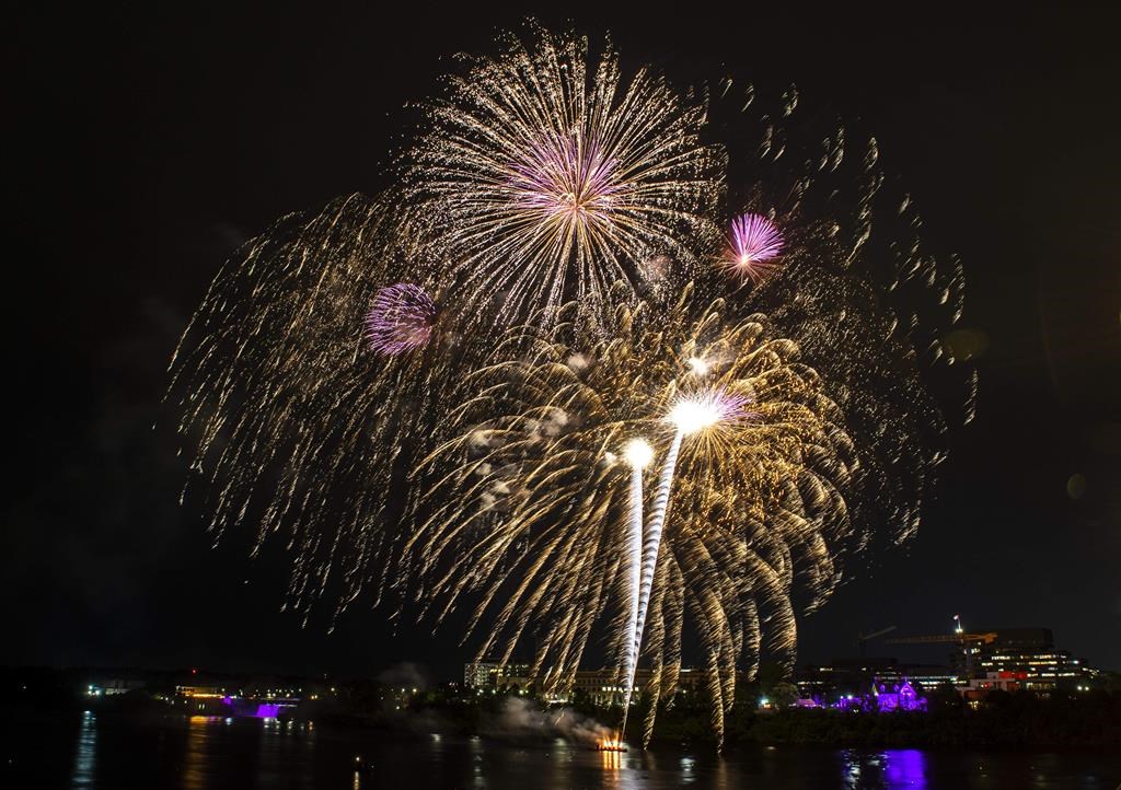Fireworks explode in the air above the Ottawa River to celebrate the Queen’s Platinum Jubilee, in Ottawa on June 2, 2022. THE CANADIAN PRESS/Justin Tang
