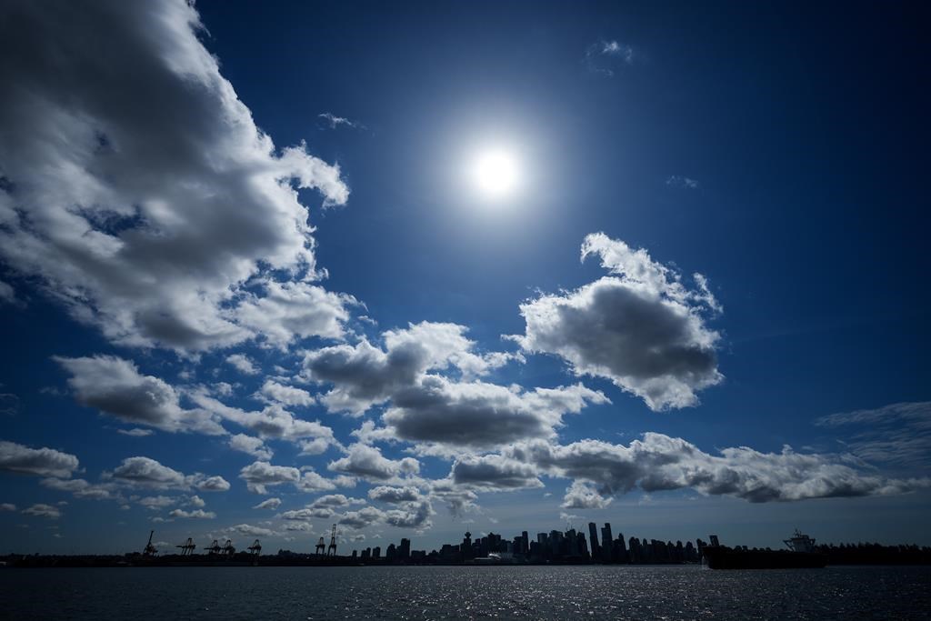 Cloud breaks bring cheers from partial solar eclipse watchers at