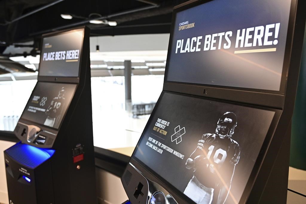 Betting kiosks are seen inside Caesars Sportsbook inside Rocket Mortgage FieldHouse, Thursday, Dec. 29, 2022, in Cleveland. Legalized sports betting continued its expansion in 2023 with six states either passing legislation or beginning to accept wagering, Fanatics got into the business and professional leagues and college athletics continued to further embrace the industry. (AP Photo/David Dermer, File)