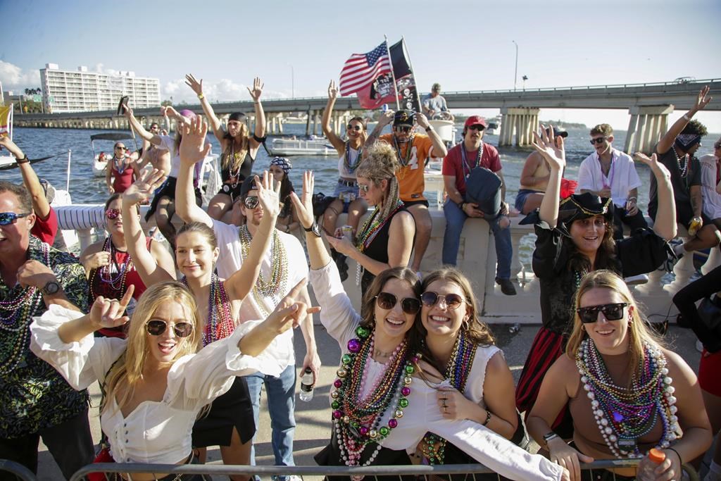 Revelers in festive dress fill downtown Tampa, Florida, for the annual