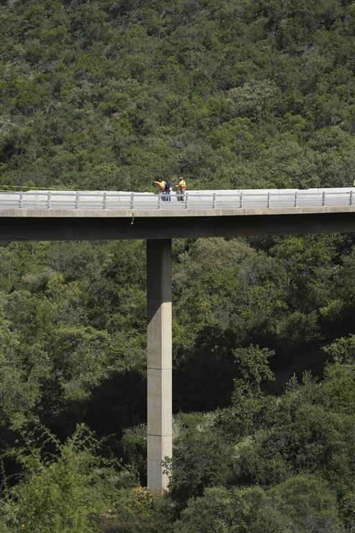 Burned bodies of Easter pilgrims still lie inside a bus that crashed off a bridge in South Africa