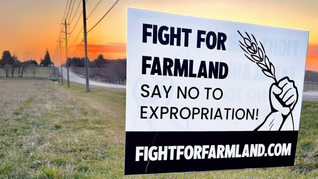 A sign that says Fight for Farmland, Say No to Expropriation
