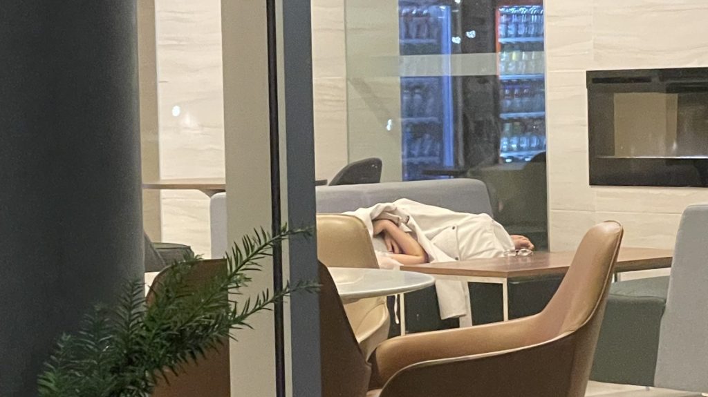 A person sleeps inside the air conditioned lobby, waiting for the A/C to be repaired in their building. (Courtesy of student living inside 256 Phillip St. in Waterloo.)