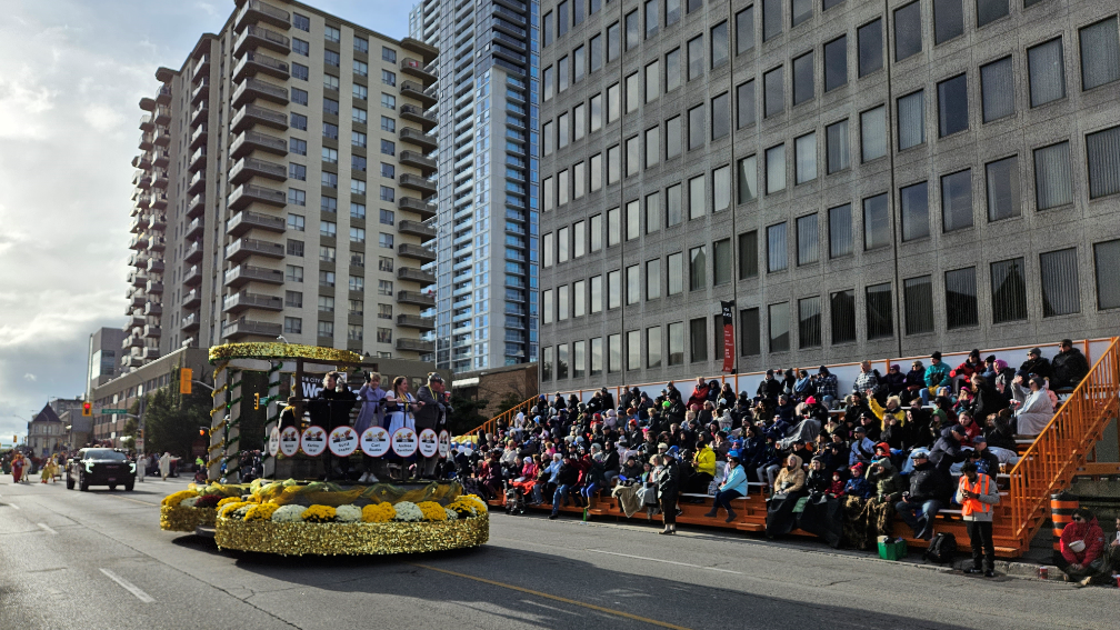 people watching a parade and a float