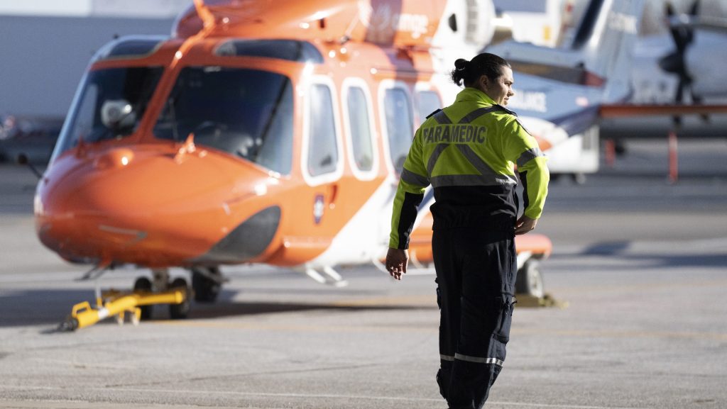 A medic walks past an ORNGE air ambulance