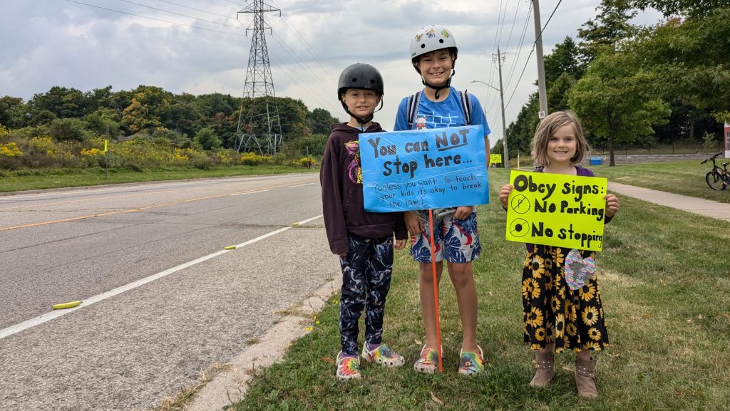 Kitchener family lines busy street with bananas to educate drivers about bike safety