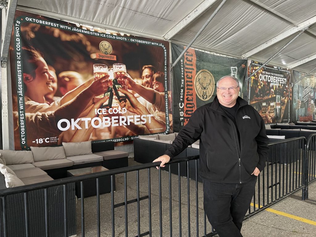 mark bingeman behind an Oktoberfest sign