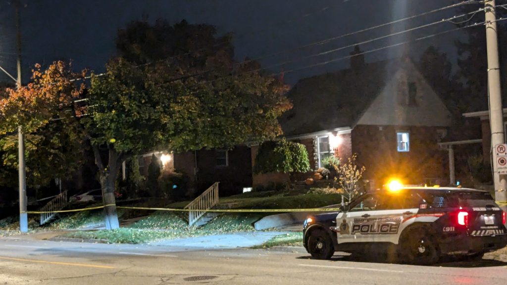 A lone police cruiser sits outside a home on Weber Street East by Raymond Road.