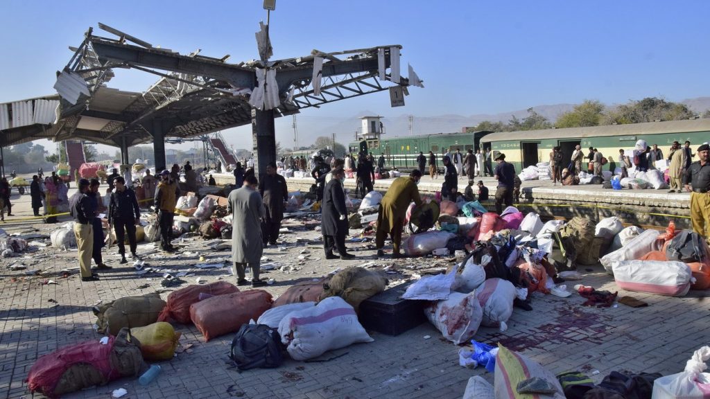 Security officials examine the site of a bomb explosion at railway station in Quetta, southwestern Pakistan, Saturday, Nov. 9, 2024.