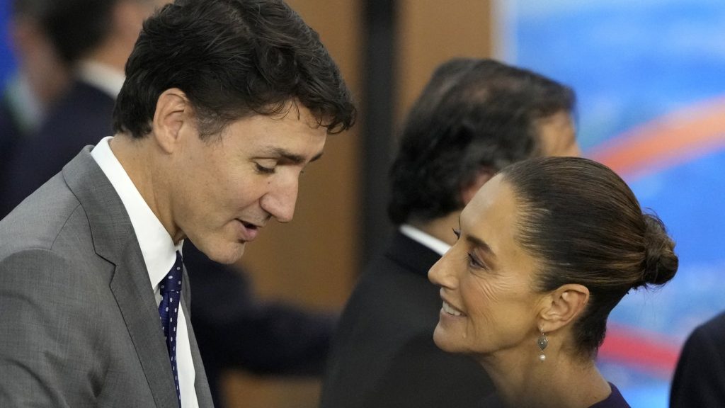 Canada's Prime Minister Justin Trudeau, left, and Mexico's President Claudia Sheinbaum talk during the G20 Summit leaders meeting in Rio de Janeiro, Monday, Nov. 18, 2024. (AP Photo/Eraldo Peres)