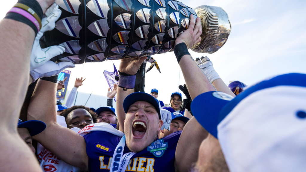 Canadian quarterback Taylor Elgersma lifting the Yates Cup with the Golden Hawks. (File photo)