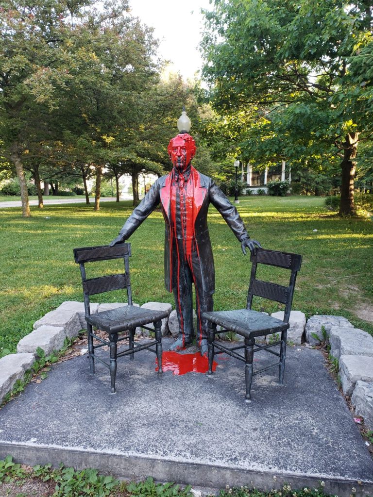 A statue of John A. MacDonald covered in red paint. (File photo)