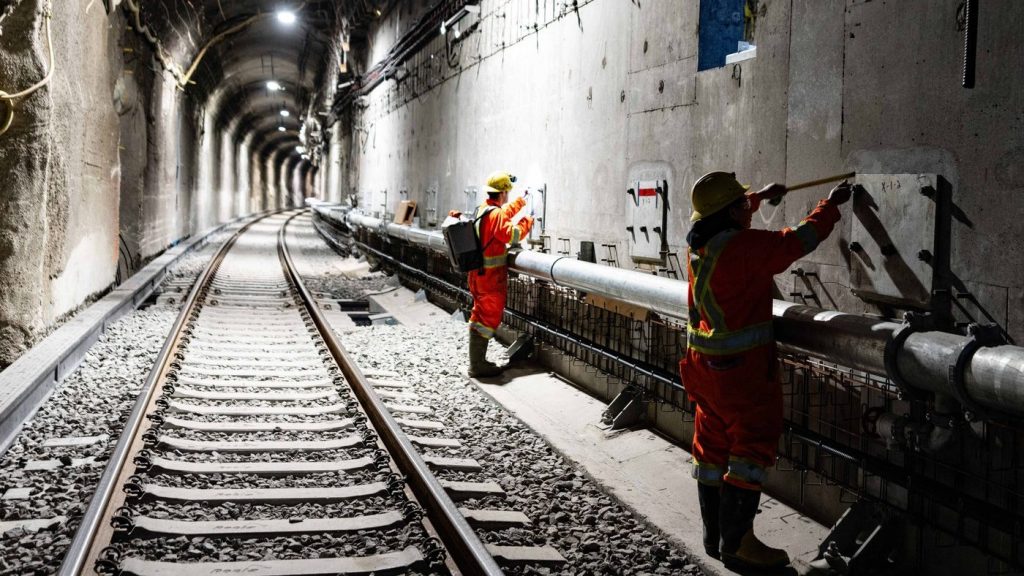 Workers inspect walls in the Mount Royal tunnel as construction progresses for an electric light rail system in Montreal, Wednesday, May 1, 2024. THE CANADIAN PRESS/Christinne Muschi