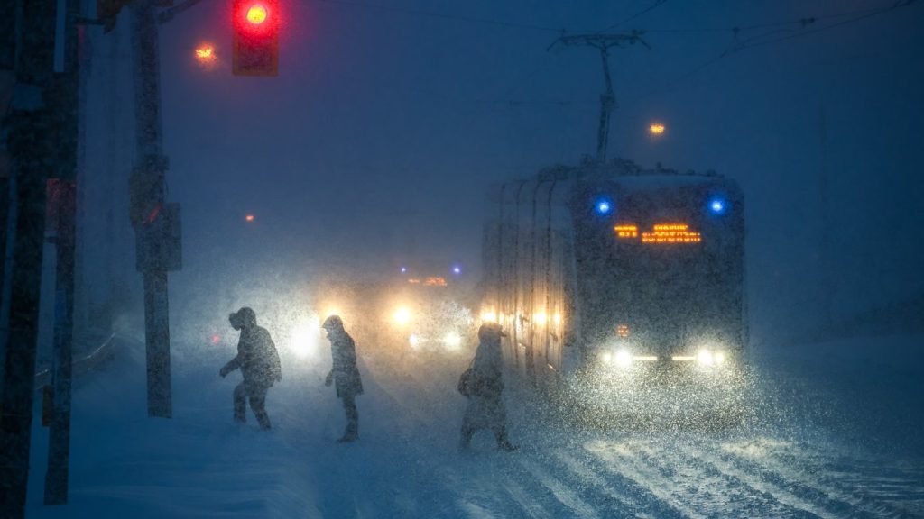 People walk through downtown Toronto as a winter storm moves through the region on Sunday, Jan. 25, 2026. THE CANADIAN PRESS/Cole Burston