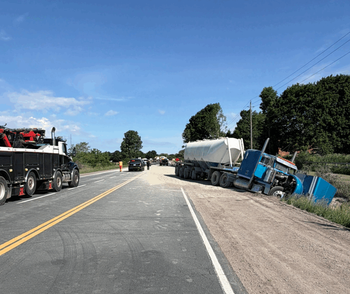 A transport truck sits partially in the ditch on Highway 6 after an earlier collision. (Wellington County OPP)